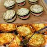 Uvařené baklažány na talíři s bylinkami a olivovým olejem