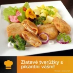 Zlatavé smažené tvarůžky obalené pikantním salámem na talíři